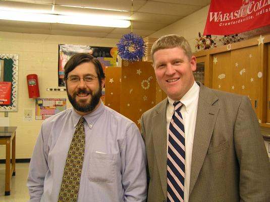 a couple of men in a classroom