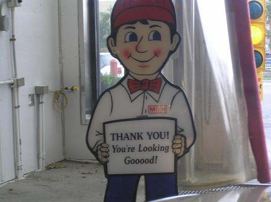 a cartoon character holding a sign