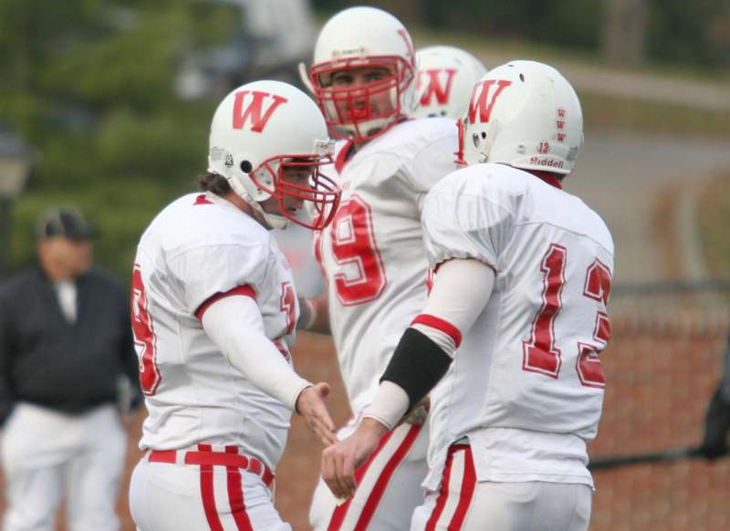 a group of football players in white and red uniforms