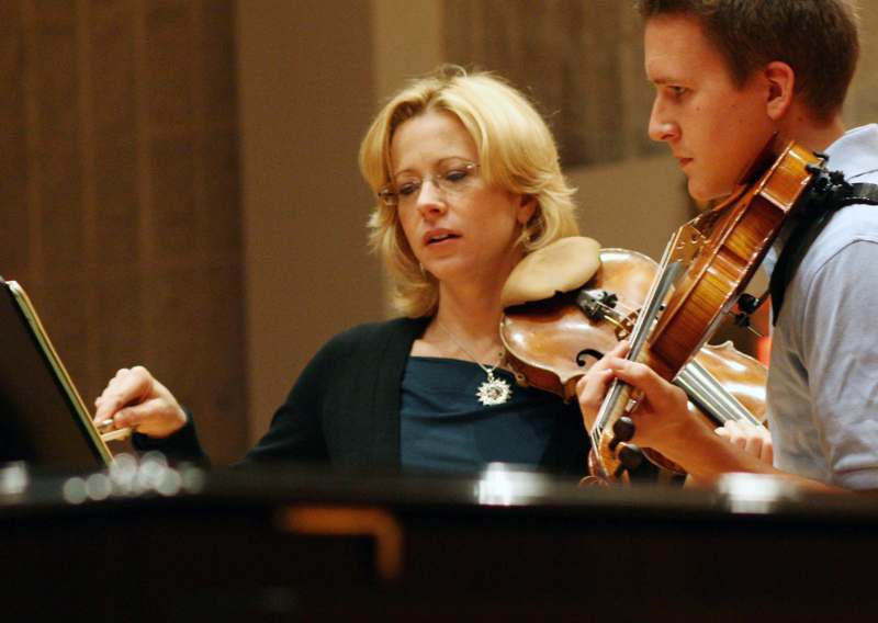 a woman and man playing violin