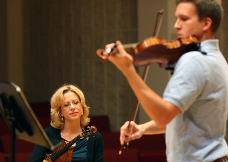a man and woman playing violin