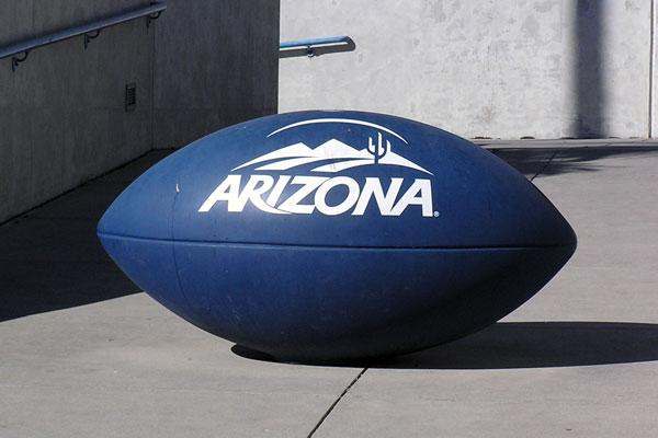 a large blue football on a concrete surface