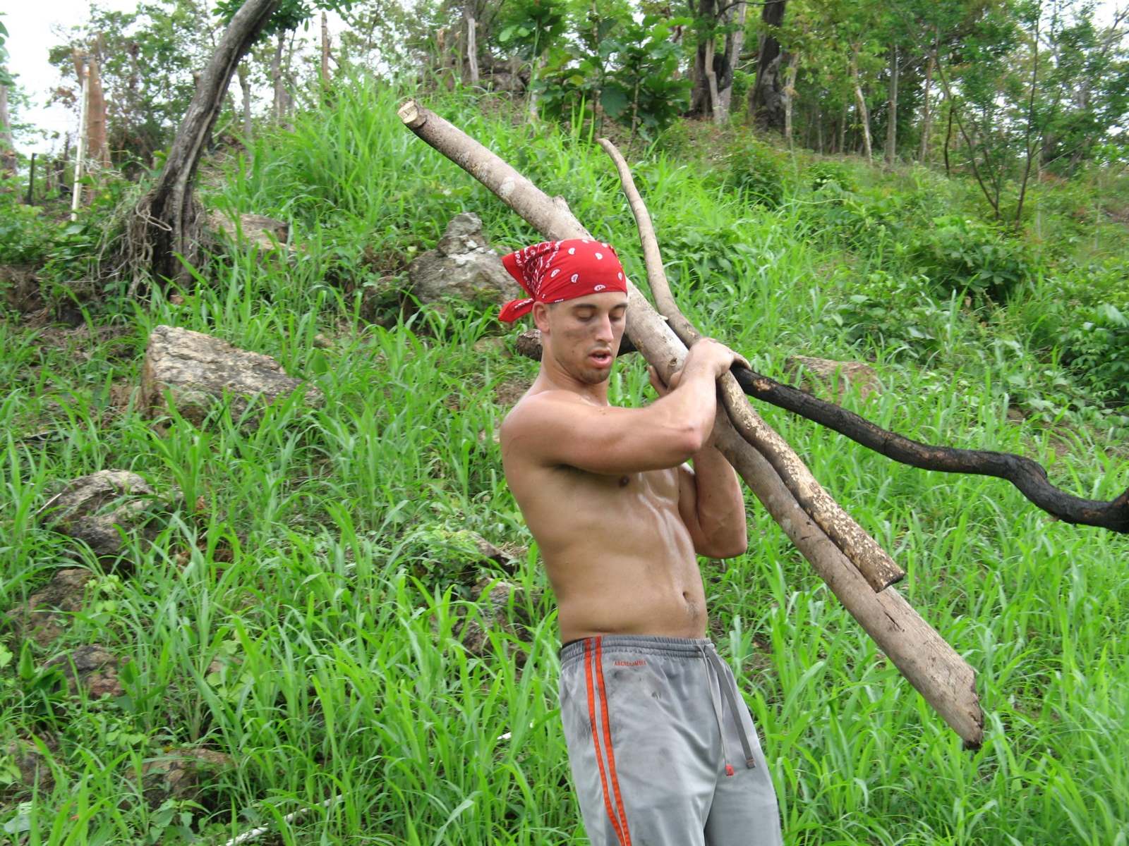 a man holding a bundle of wood