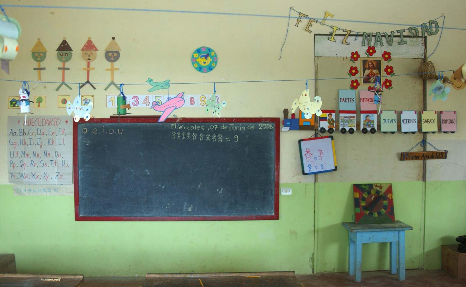 a classroom with a chalkboard and pictures on the wall