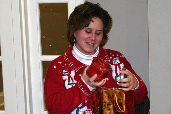 a woman holding a jar and a bag