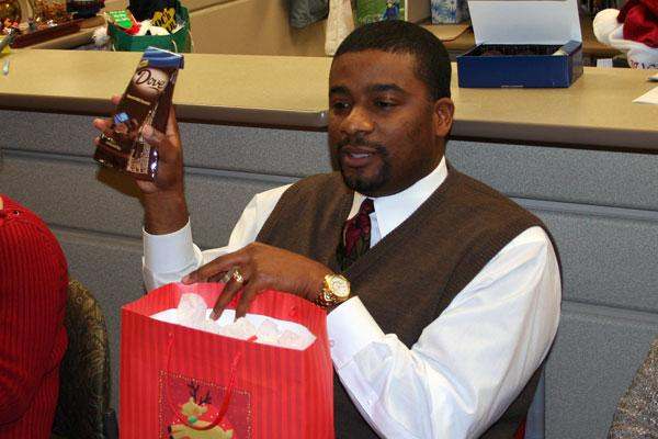 a man holding a bag and a chocolate bar