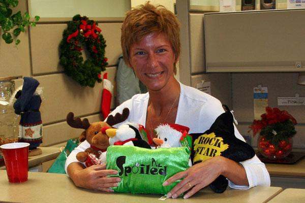 a woman holding a bag of stuffed animals
