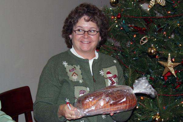 a woman holding a loaf of bread