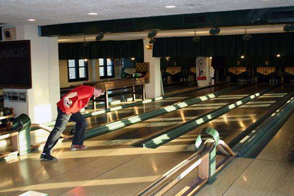 a man in a red shirt bowling