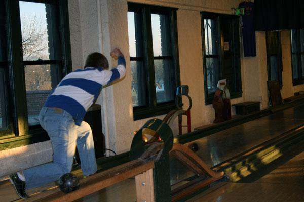 a man bowling on a bowling alley