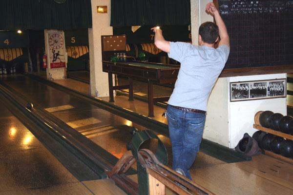 a man standing on a bowling alley