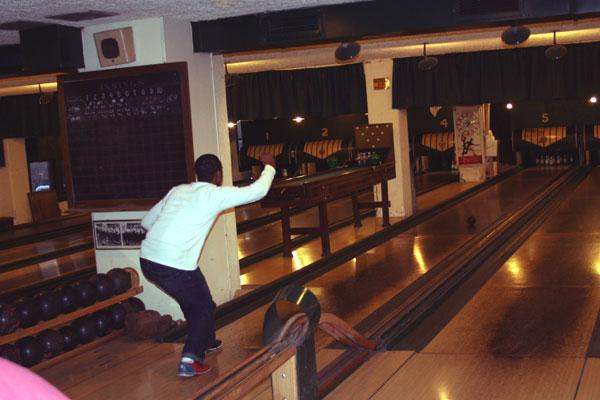 a man throwing a bowling ball