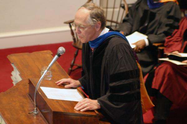 a man in a robe at a podium