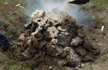 a pile of dirt with smoke