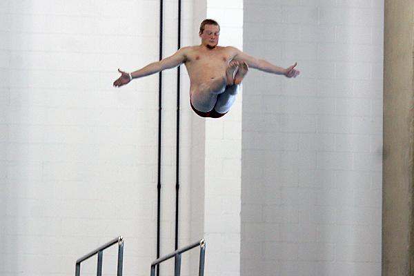 a man jumping into a pool