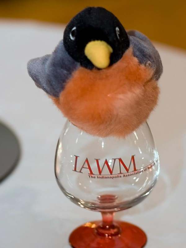 a stuffed bird on a wine glass