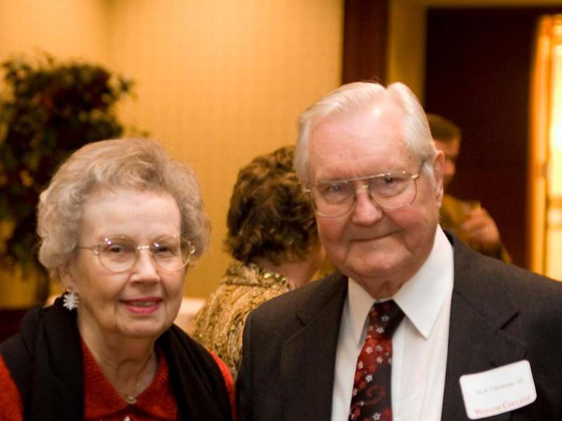 a man and woman smiling at the camera