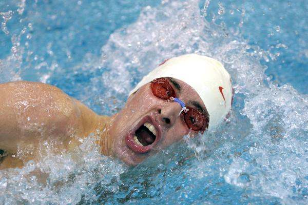 a man wearing goggles and swimming cap
