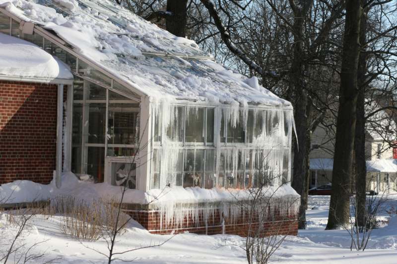 a greenhouse covered in snow
