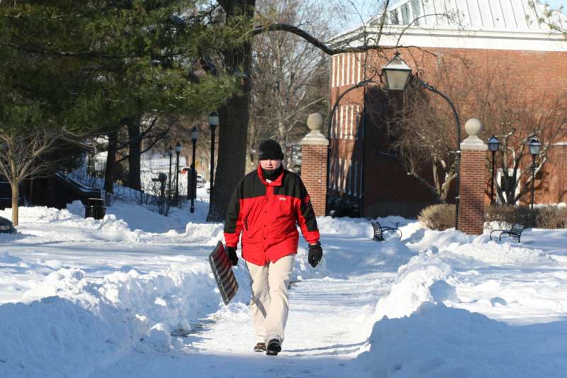 a man walking on a snowy path