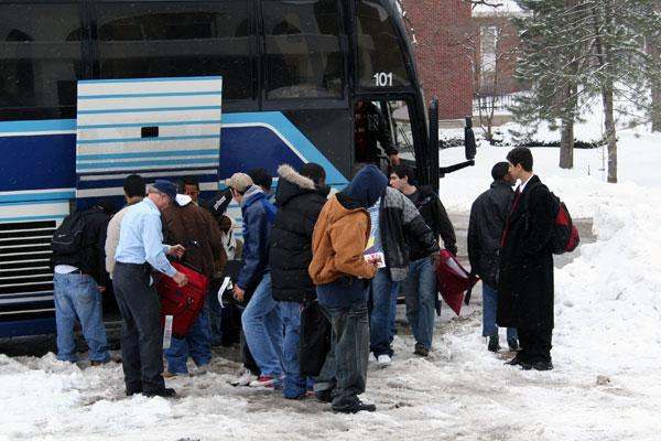 a group of people getting off a bus