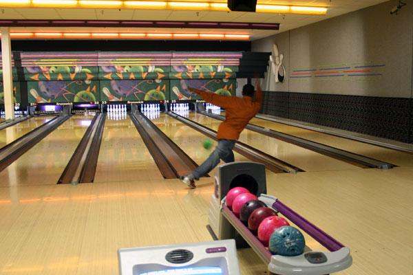a man throwing a bowling ball