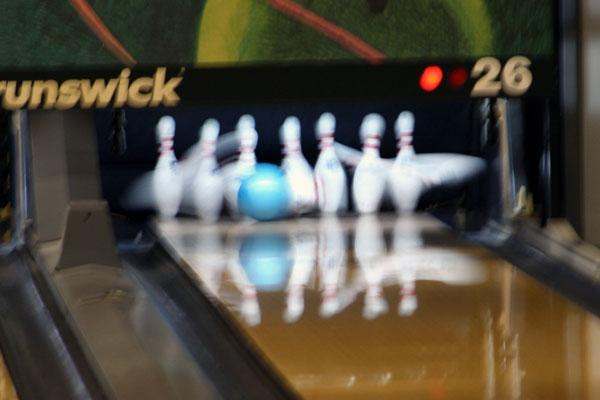 a bowling alley with bowling pins and a ball