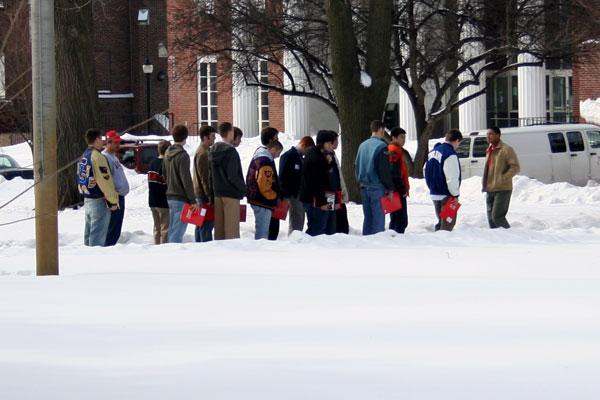 a group of people standing in the snow
