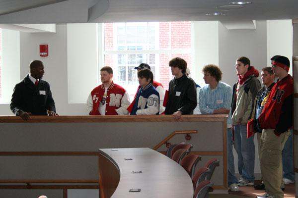 a group of people standing next to a desk