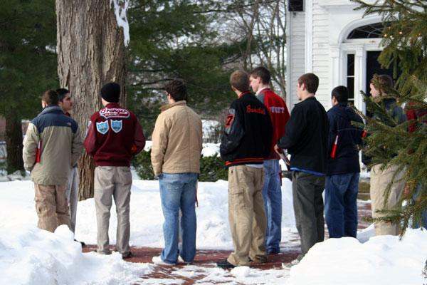 a group of people standing outside in the snow