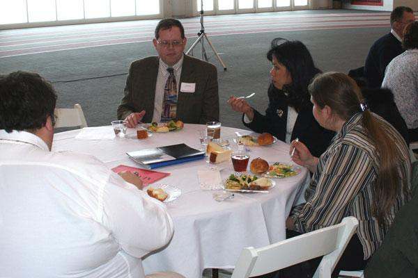 a group of people eating at a round table