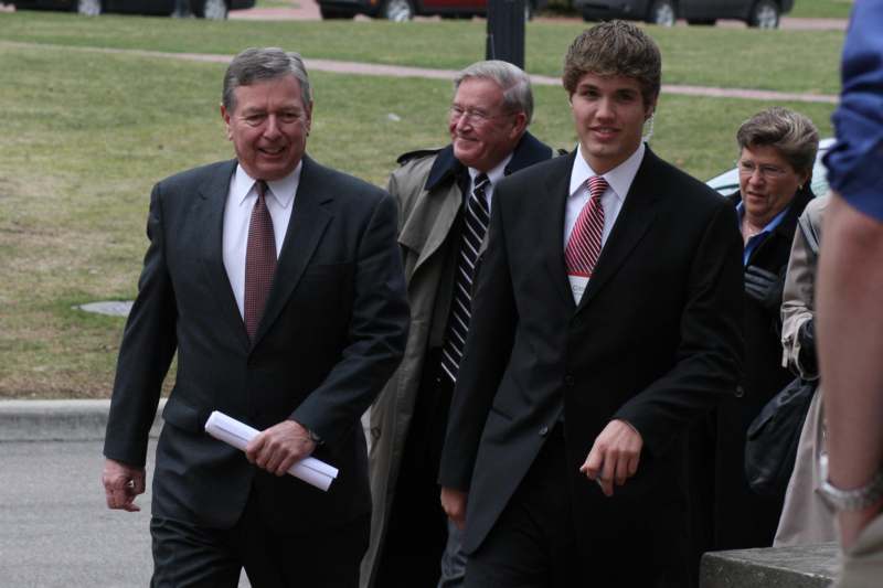 a group of men in suits walking