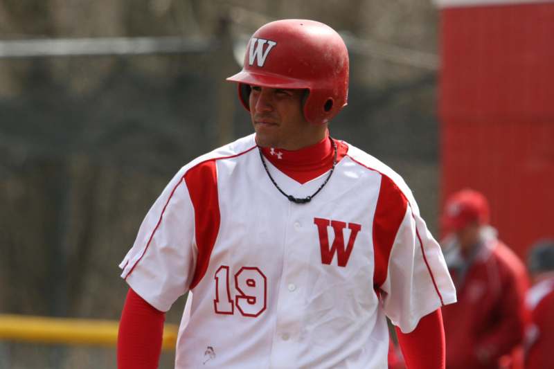 a baseball player wearing a red helmet