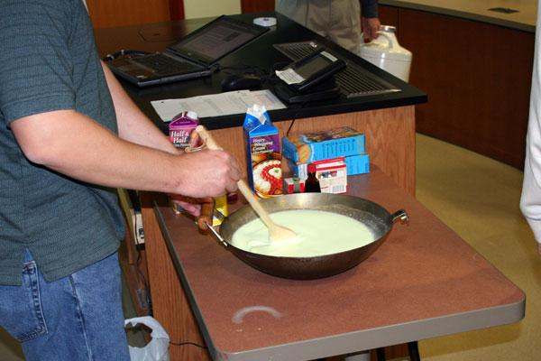 a person mixing milk in a pan