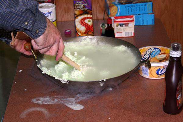 a person stirring a pan of liquid