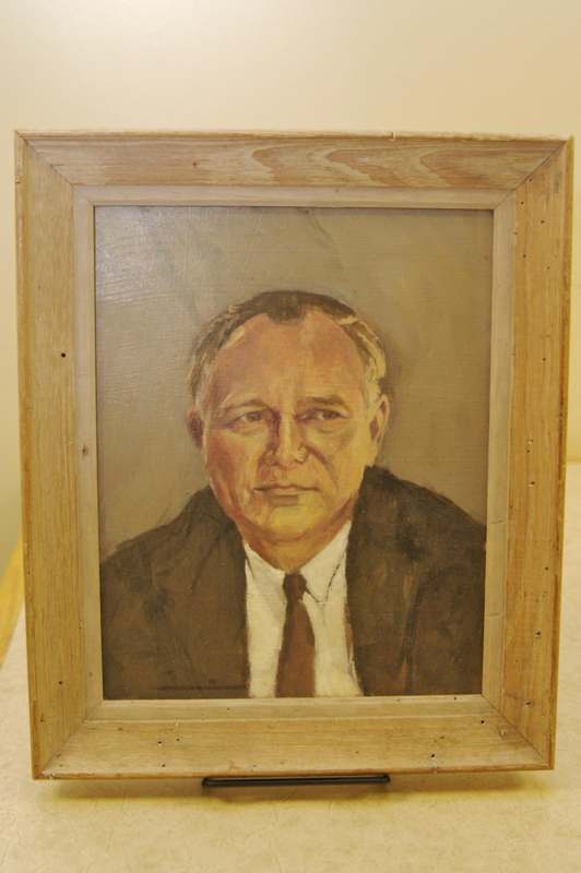 a painting of a man in a wooden frame