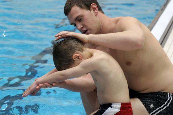 a man and child in a pool