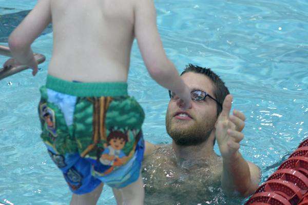 a man in a pool with a child