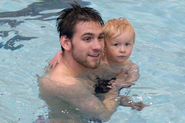 a man and child in a pool