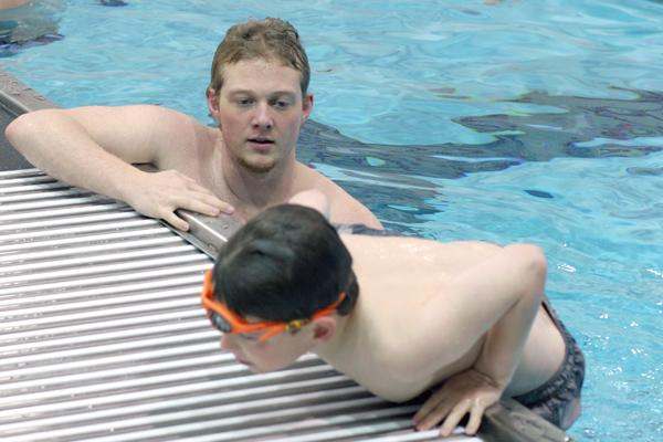 a man and boy in a pool