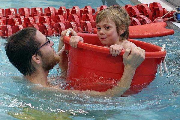 a man and child in a pool