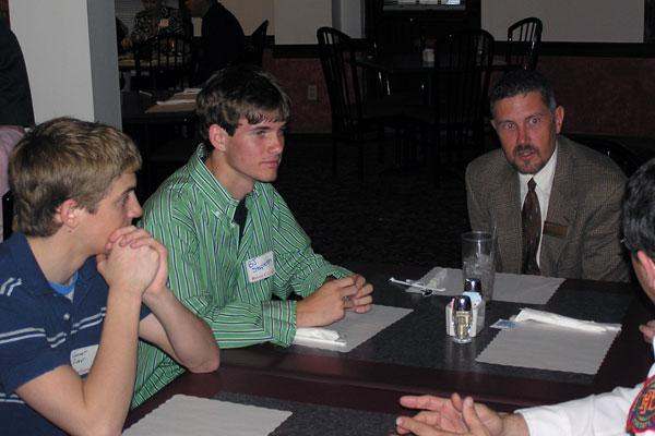 a group of men sitting at a table