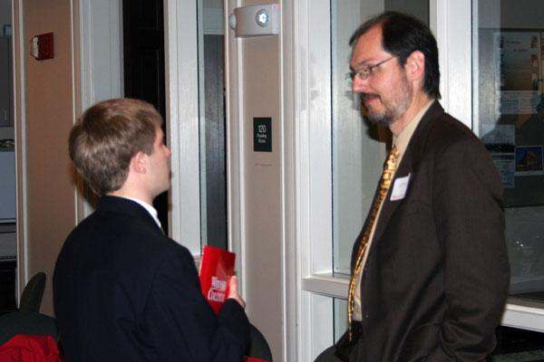 a man in a suit talking to a young boy