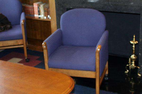 a blue chair next to a table