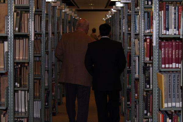 men walking through a library