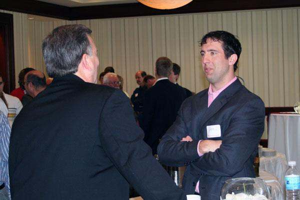a man in a suit talking to another man
