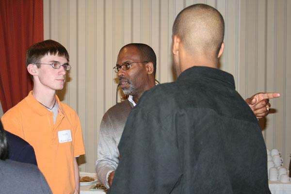 a group of men talking to each other