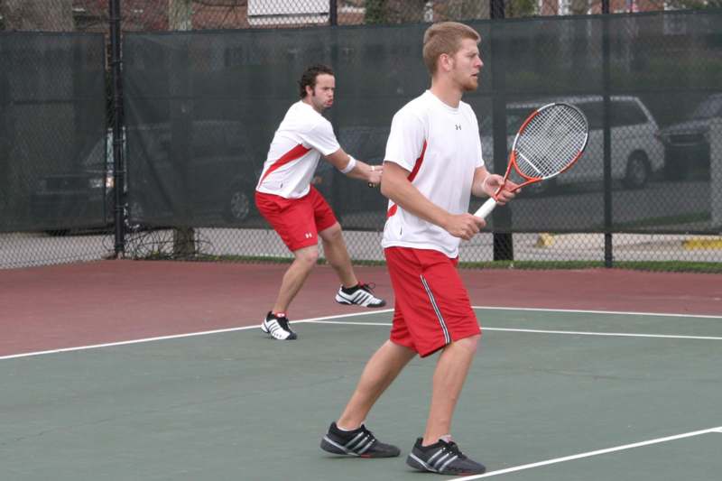 a couple of men on a tennis court