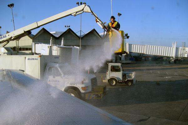 a man pouring snow from a crane