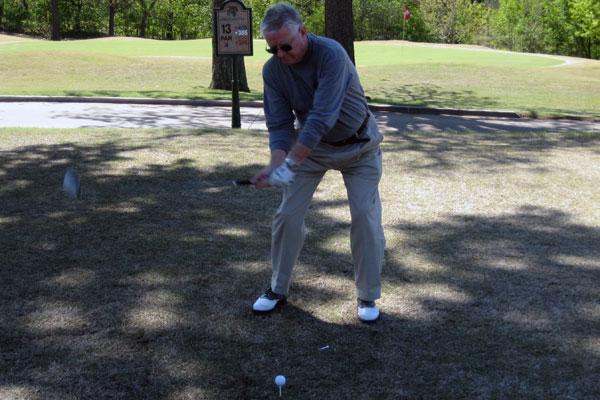 a man playing golf on a golf course